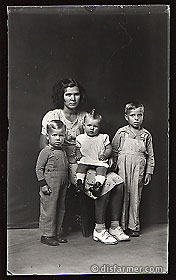 Woman with Three Children, One on Her Lap