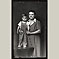 Woman in Grey Dress with Son on Platform