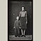 Mother Standing with Son in Overalls