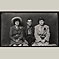 Man Holding Hat with Two Women
